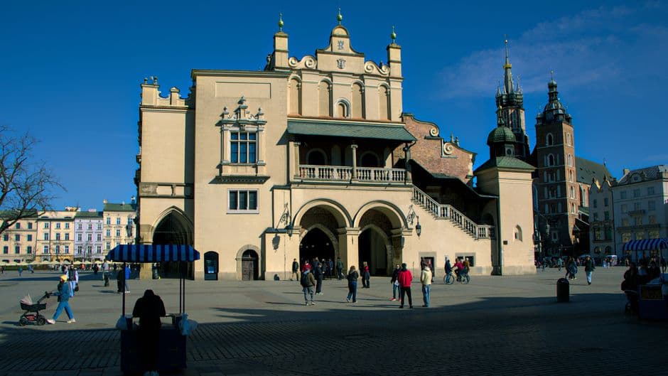 The Sukiennice Cloth Hall in the middle of Krakow's Main Market Square, with the two unequal towers of St Mary's Basilica behind it