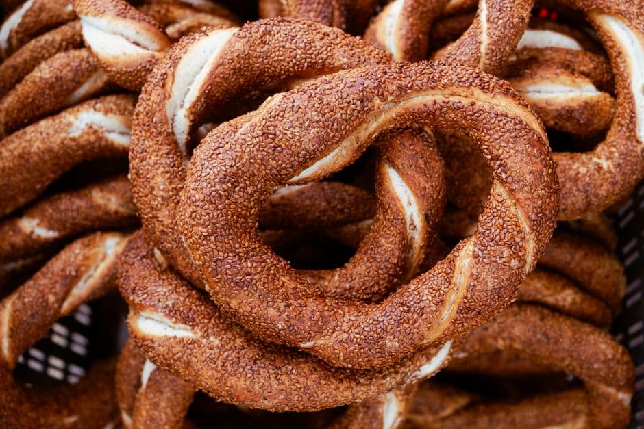 A crate of freshly baked simit, sesame-crusted bread rings made from a twisted double strand of dough