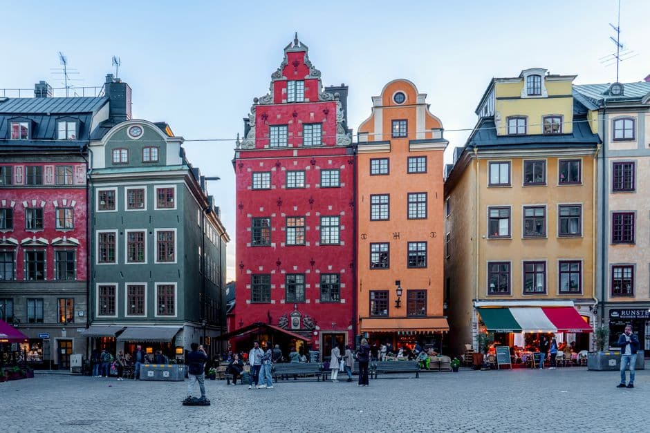 The colored gabled houses on Stortorget square in Gamla Stan, Stockholm, with restaurant awnings and tables at street level