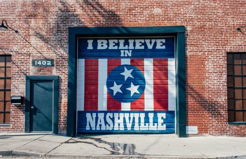The I Believe in Nashville mural, painted with the Tennessee tri-star flag on a red brick building