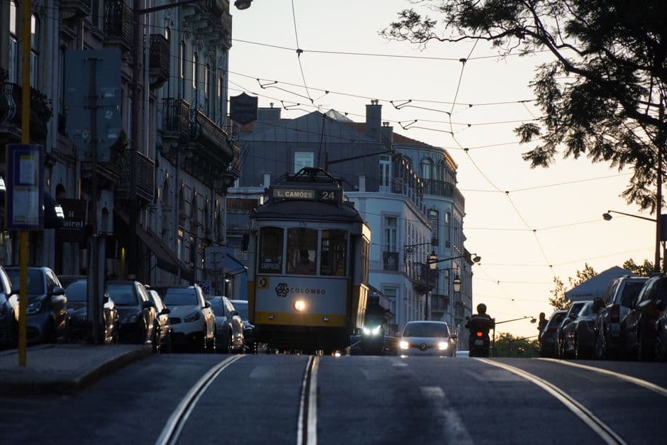 Yellow tram climbing a Lisbon street, the setting for a where to eat in Lisbon neighborhood guide