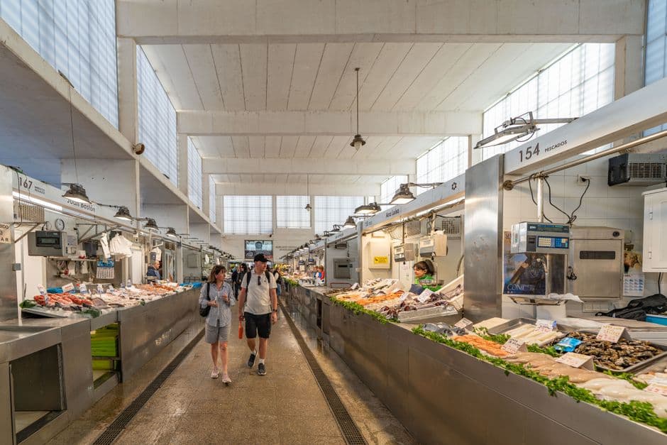 Stalls inside a covered food market hall, the Time Out Market format for eating in Lisbon